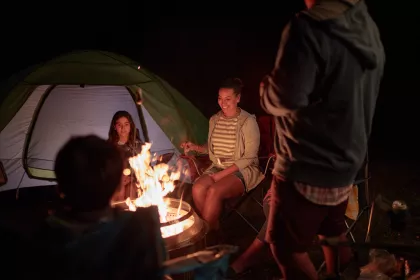 A family gathers around a campfire at William O'Brien State Park