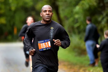 A runner competes in the Autumn Woods Classic