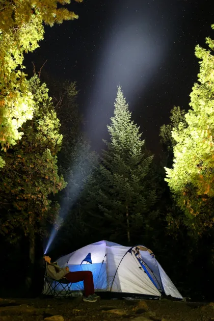 A camper aims their headlight at the stars in Superior National Forest