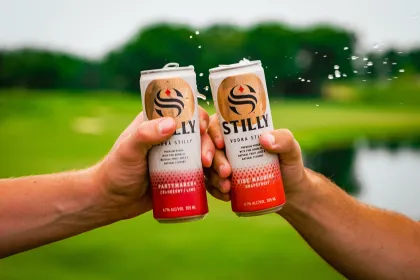 A couple fans toast one another at the 3M Open