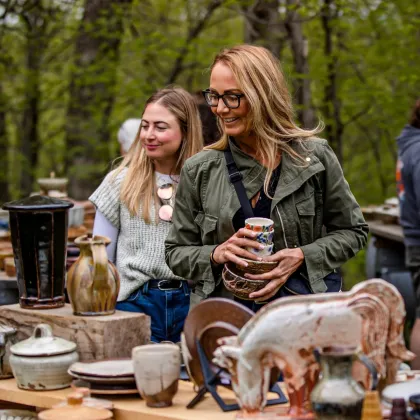 Women shop at Guillermo Cuellar's studio, part of the St. Croix Valley Pottery Tour