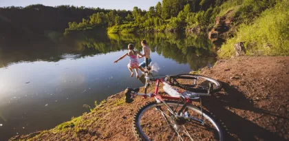 A couple kids jump into the LaRue Mine pit that is now a lake