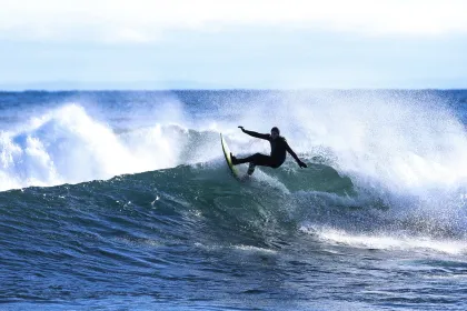 A surfer rides the waves at Stoney Point