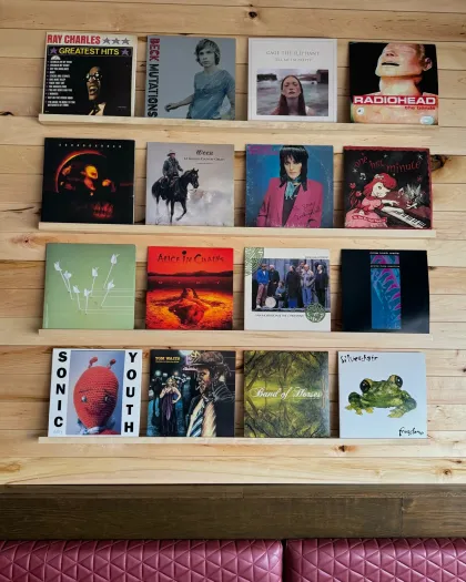 A wall of vinyl records at Good Life Cafe