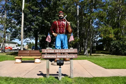 The Paul Bunyan statue and s'mores bench next to A-Pine Restaurant