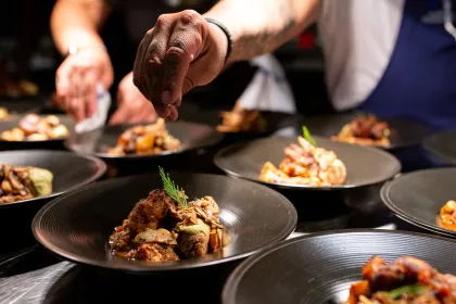 Owamni's chefs plate dishes at dinner