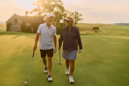 A couple walks along Wildflower Golf Course during a sunny afternoon