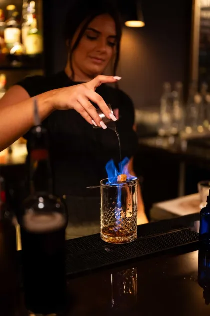 A bartender prepares a cocktail at Bitter and Pour