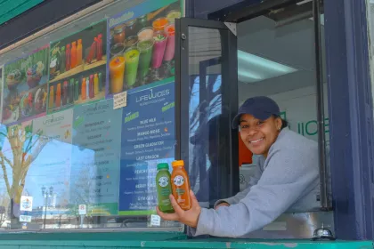 An employee working at the window in Life Juices Super Food Bar