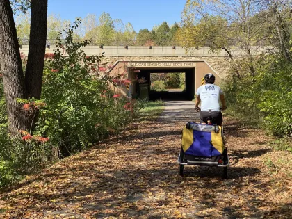 A family rides a bike along the Sakatah Singing Hills State Trail