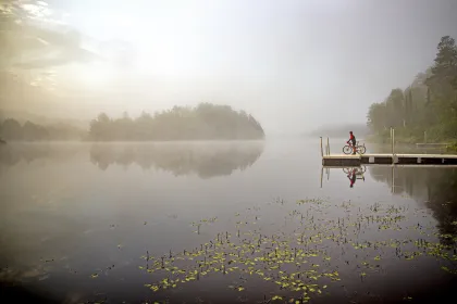 A cyclist on the Wynn Lake pier along the Mesabi Trail