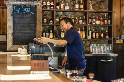 A bartender pours a drink at Irma's Kitchen
