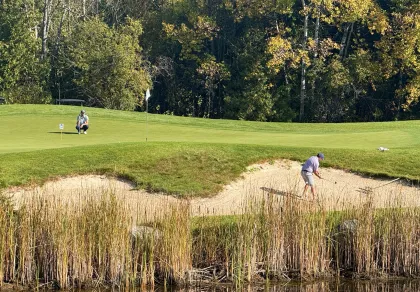 A couple golfers at Fortune Bay's Wilderness course