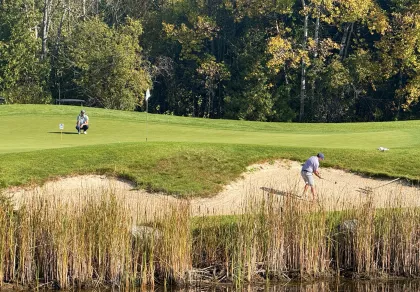 A couple golfers at Fortune Bay's Wilderness course