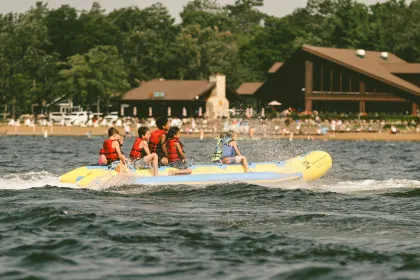 Kids ride a banana boat on Gull Lake at Grand View Lodge