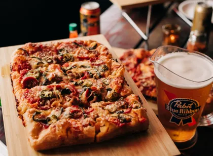 Mario's supreme pizza and a pitcher of beer