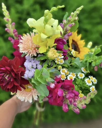 A bouquet of snapdragons, sunflowers and eucalyptus at Buds in Bloom