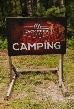 Jack Pines Resort Camping sign in the woods