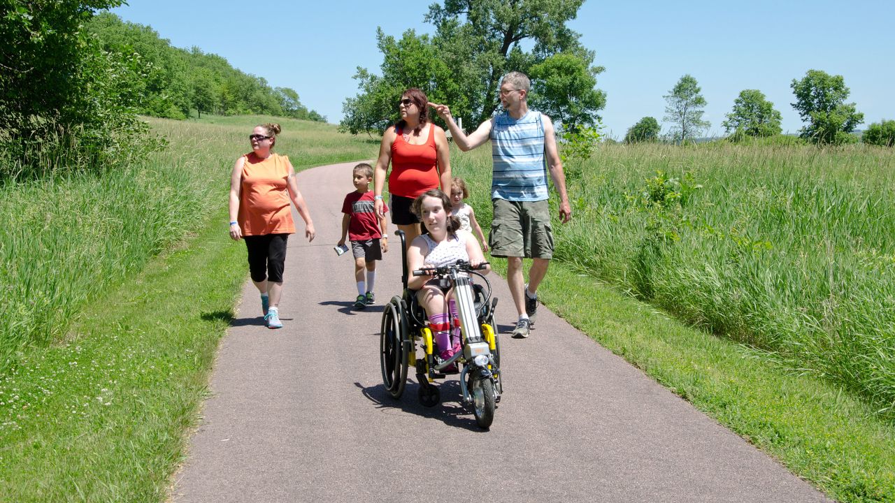 Family on wheelchair-accessible trail at Blue Mounds State Park