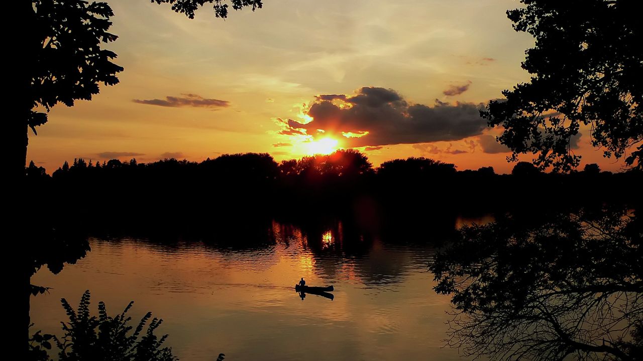 A fishing boat on a lake at sunset in Fairmont
