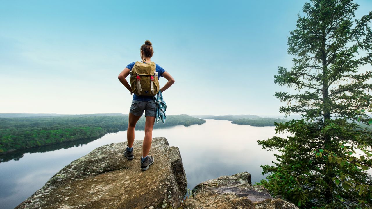 Female hiker at the top of Honeymoon Bluff in Grand Marais
