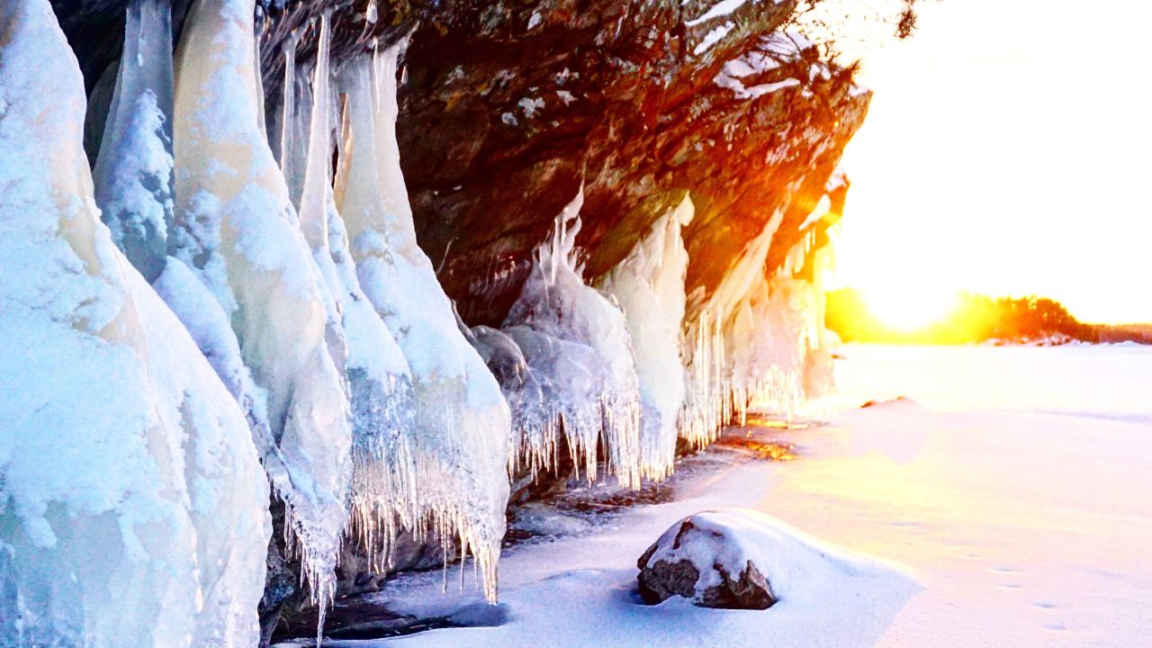Sunrise over a snowy cliff in Voyageurs National Park