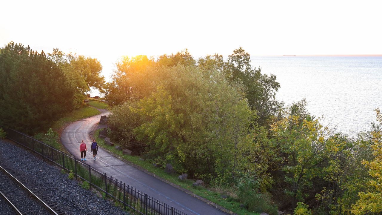 Women walking on Lakewalk sunrise Duluth