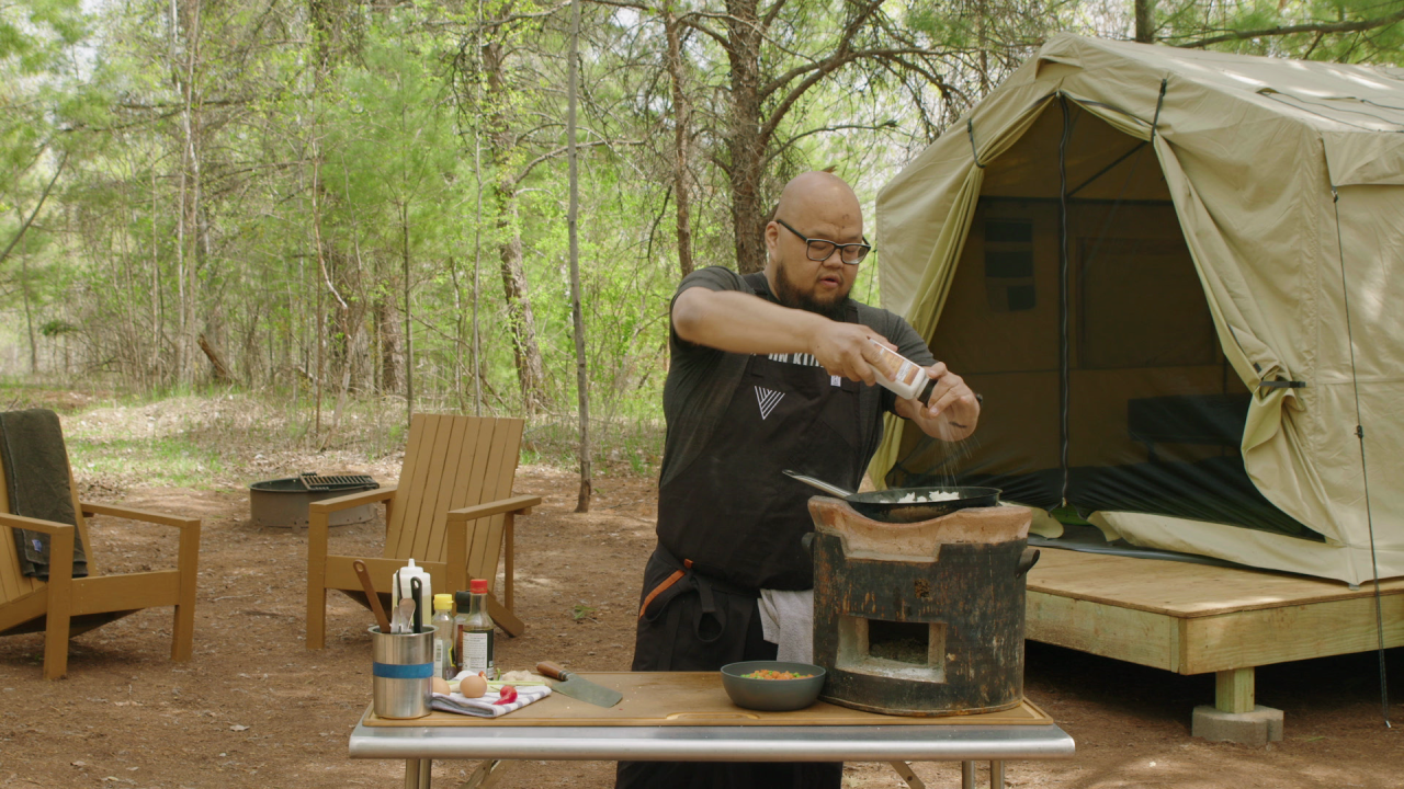 Yia Vang adding salt to Hmong fried rice