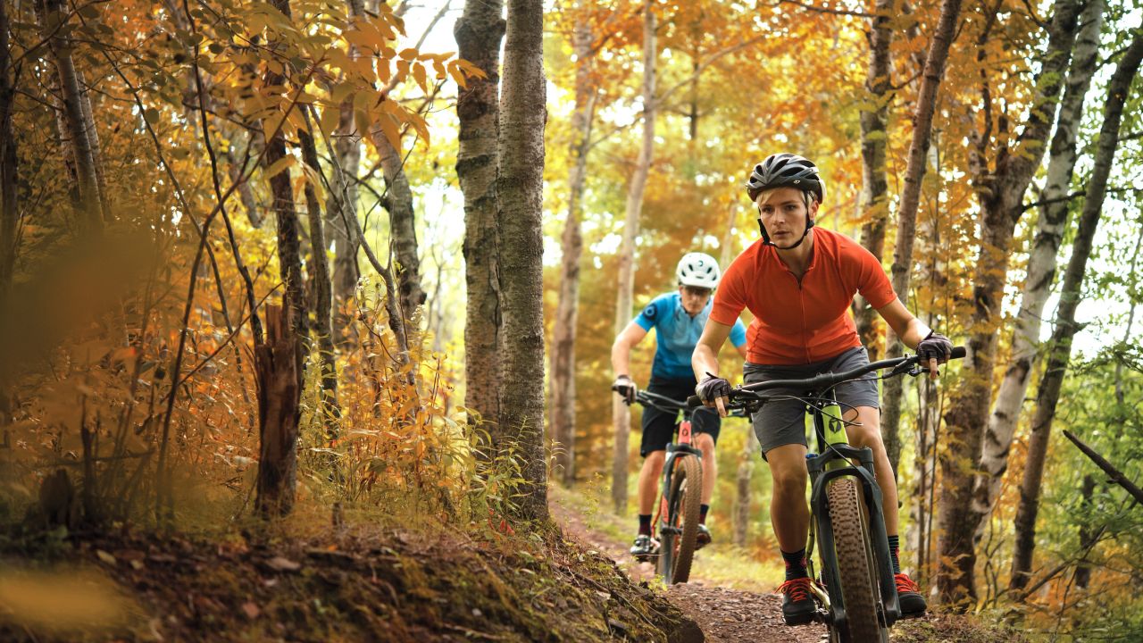 A couple goes mountain biking in Cuyuna during the fall