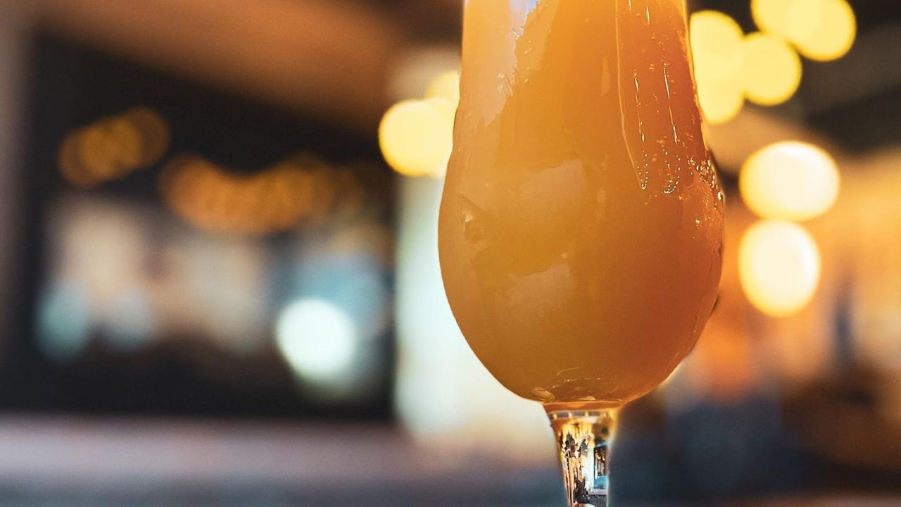 A pint of NA Peach Passion Fruit Sour at 9 Mile Brewing