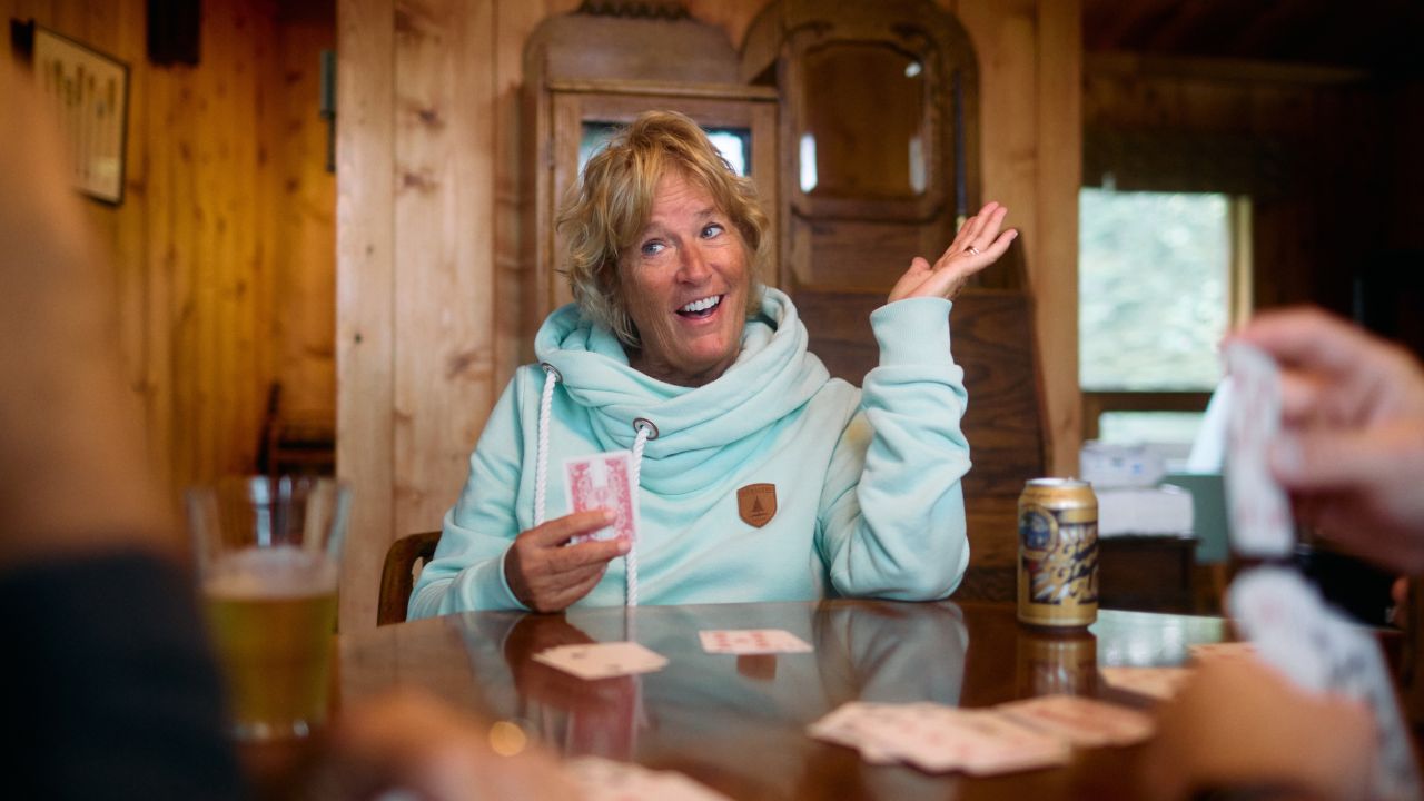 A family plays cards in their cabin at Fair Hills Resort
