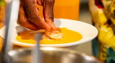 Chef Matteo Mackbee makes his shrimp bisque dish at Krewe