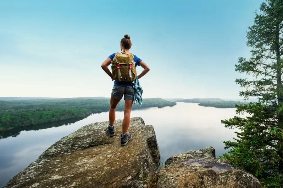 Female hiker at the top of Honeymoon Bluff in Grand Marais