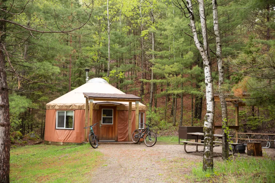 Two mountain bikes parked outside of a yurt in Cuyuna