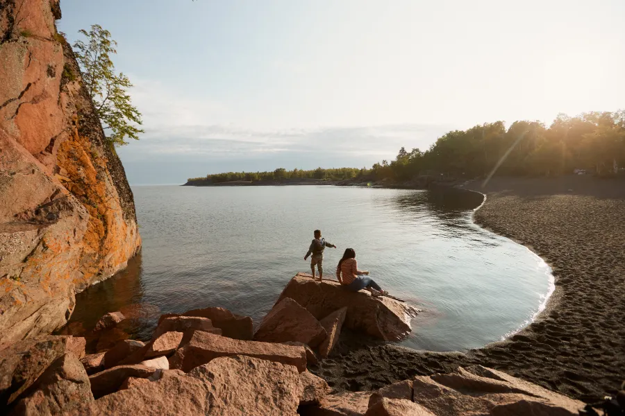 Mother and son play together by the shore of Lake Superior