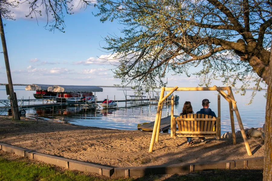 A couple on a wooden swing at Shady Grove Resort, Ottertail