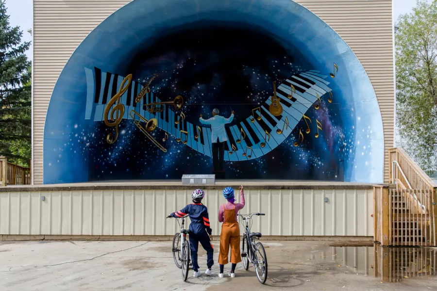 Two women biking, Sauk Centre bandshell, Lake Wobegon Trail