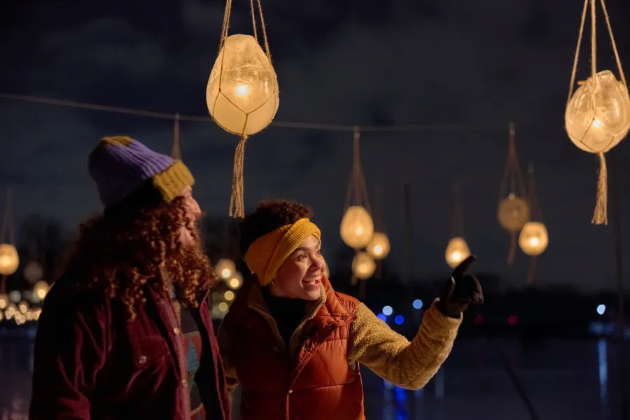 A couple stands among the lights at the Luminary Loppet in Minneapolis 