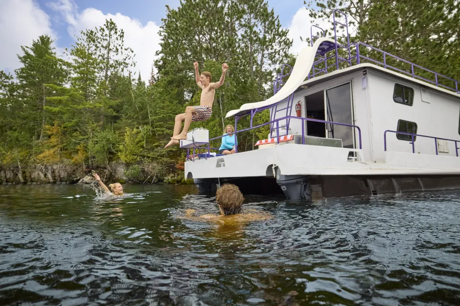 A family swims near their houseboat at Voyageurs National Park