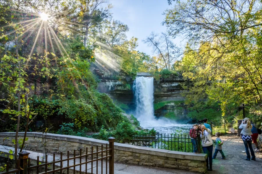 Families pose in front of Minnehaha Falls