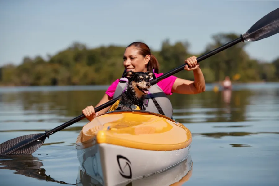 Woman and dog kayaking Chain of Lakes Minneapolis