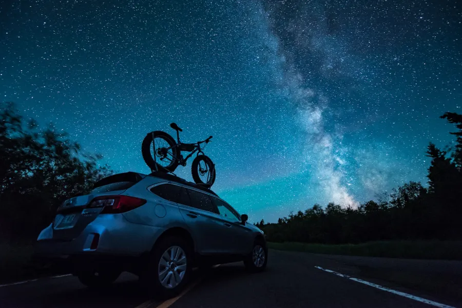 A car parked beneath the Milky Way 