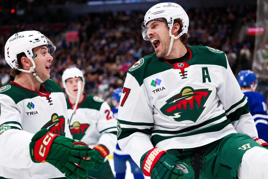 Minnesota native Brock Faber and winger Marcus Foligno celebrate a win over the Toronto Maple Leafs