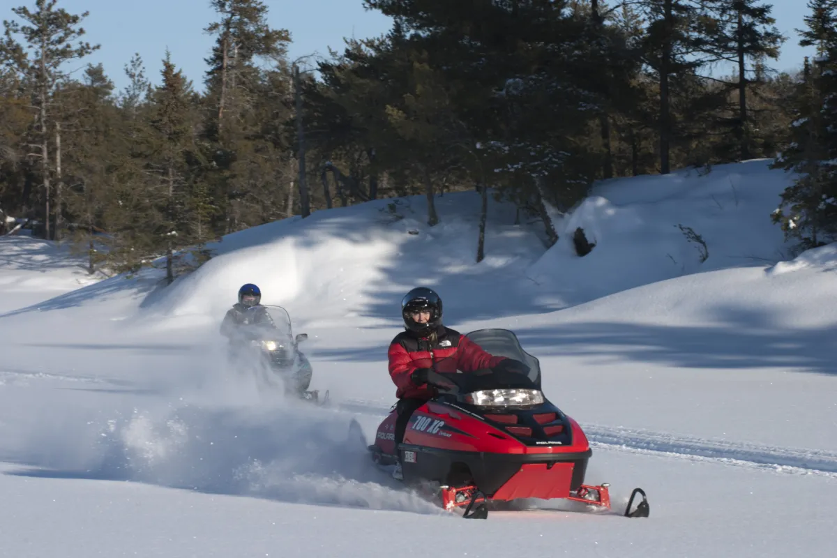 Snowmobiling on trails in Voyageurs National parkP