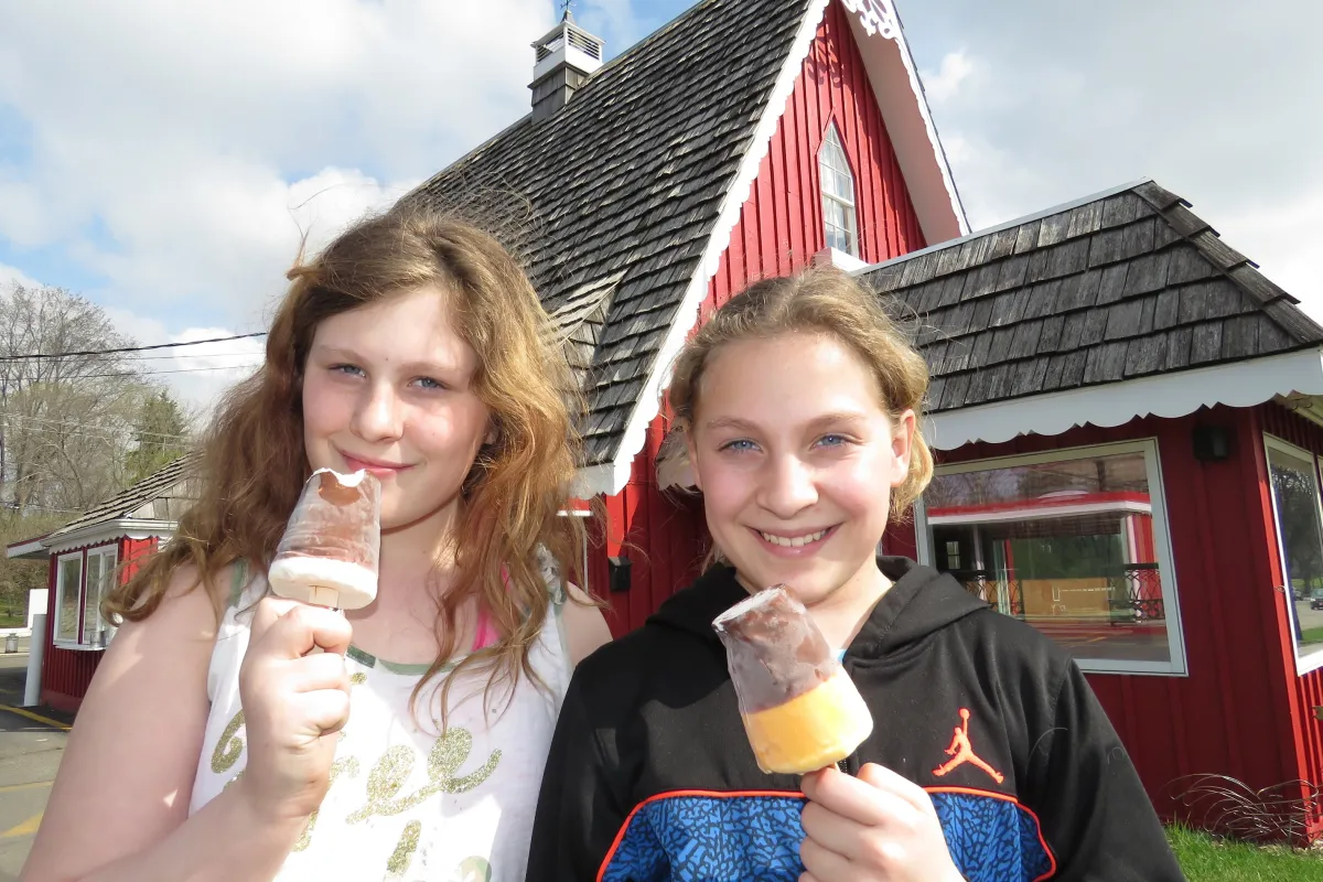Girls eating ice cream outside Dairyland restaurant