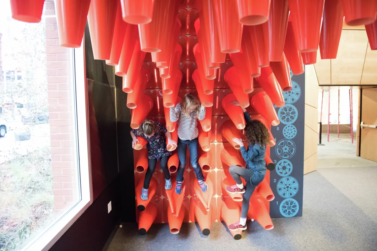 Kids climb on interactive safety cone exhibit