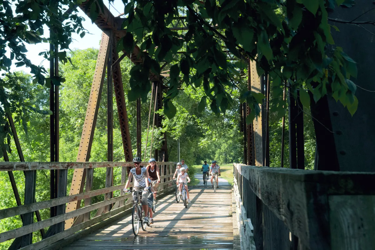 Biking over a bridge on the Root River Trail
