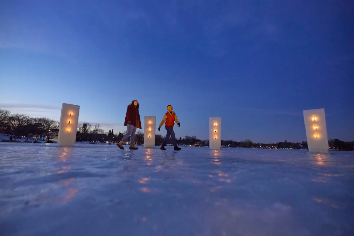 A couple friends walk along the Luminary Loppet in Minneapolis