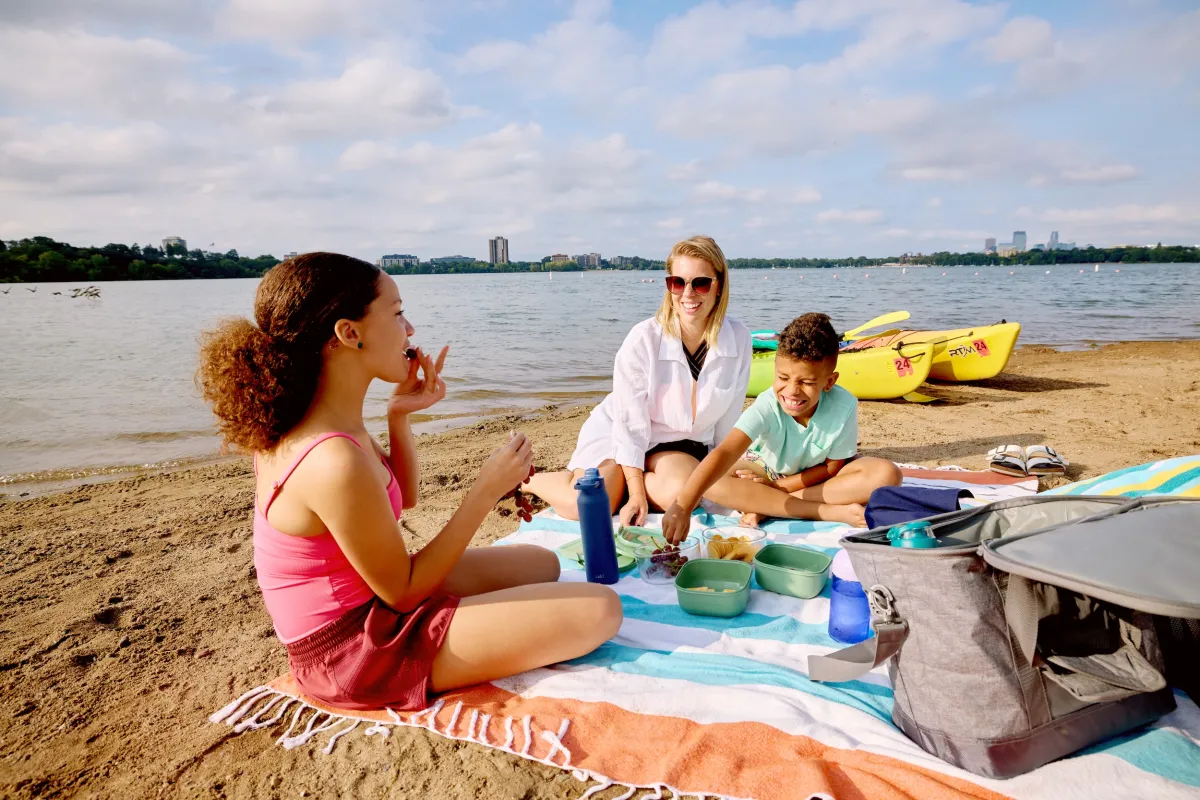 A family having a picnic on the beach at Bde Maka Ska