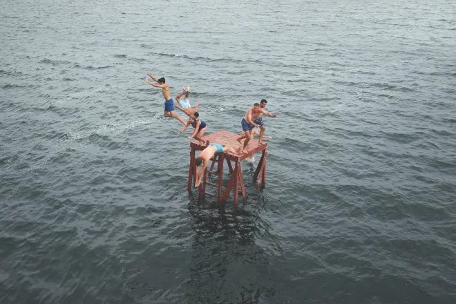 A family jumps into Pelican Lake at Fair Hills Resort